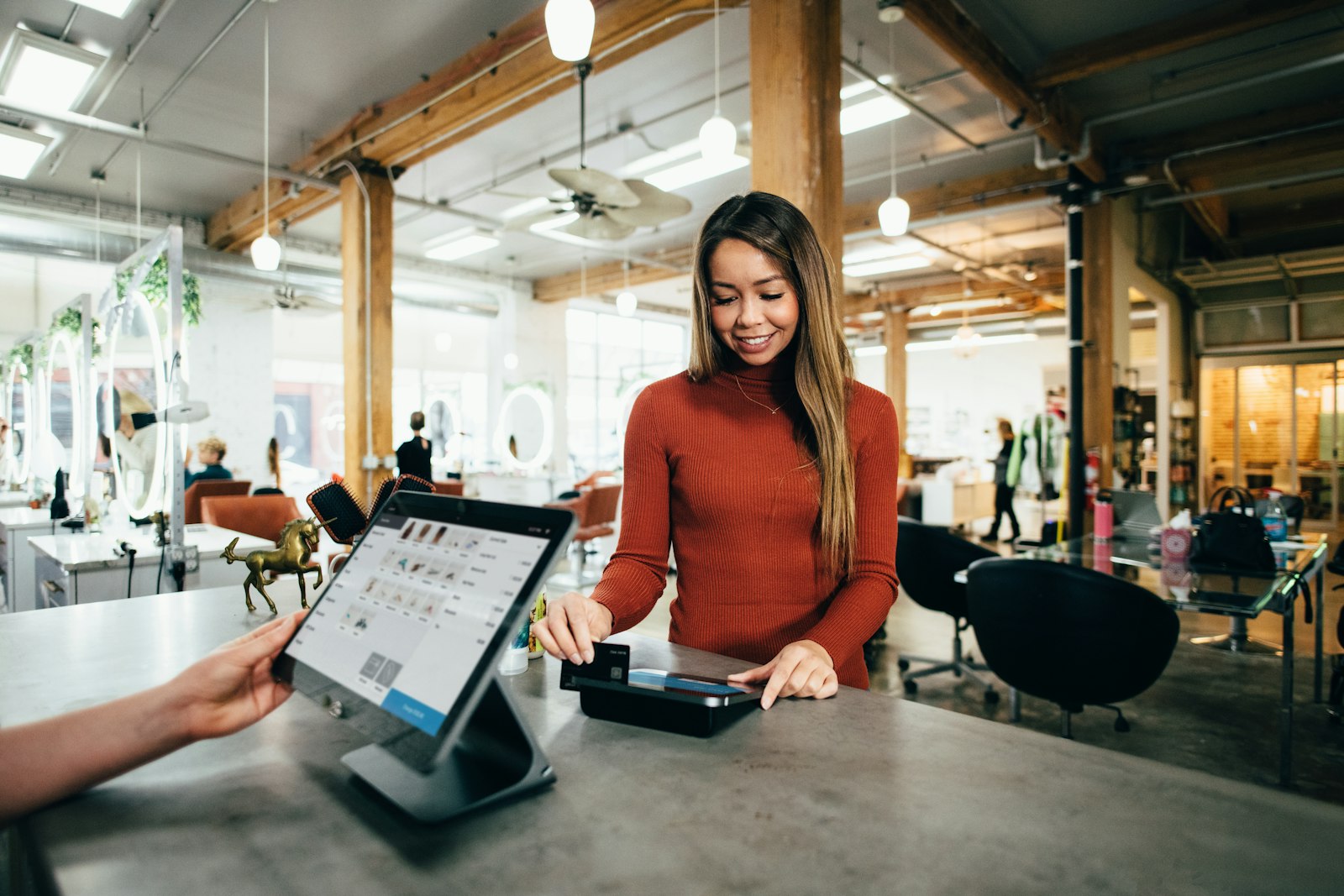 A customer paying at a small shop counter